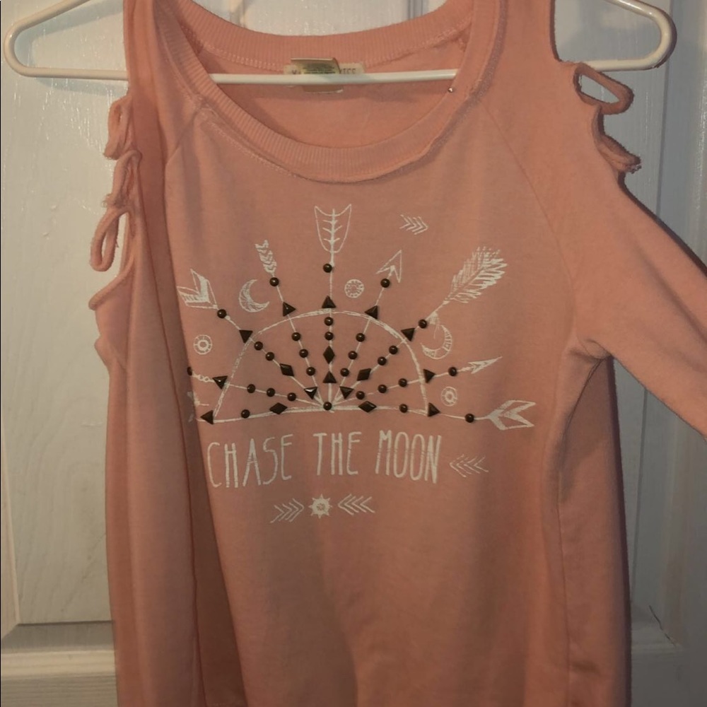 Pink sweater ripped at the shoulders